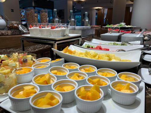 a buffet with many bowls of food on a table at Esplanade Tergesteo - Luxury Retreat in Montegrotto Terme