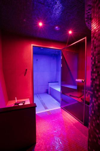 a bathroom with pink lights in a room at Crowne Plaza Gerrards Cross by IHG in Beaconsfield