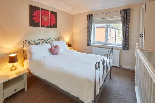 a bedroom with a white bed and a window at Host & Stay - The Limes in Harrogate
