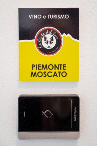 a card for a phone is attached to a wall at Vino e Turismo in San Defedente di Cervasca