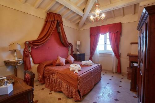 a bedroom with a bed with two animals on it at Podere San Giuseppe in Castiglione del Lago