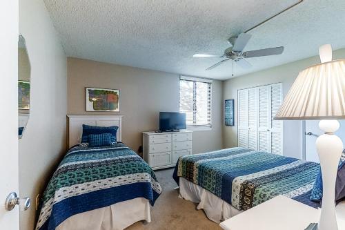 a bedroom with two beds and a ceiling fan at Island Club 5 in Hilton Head Island