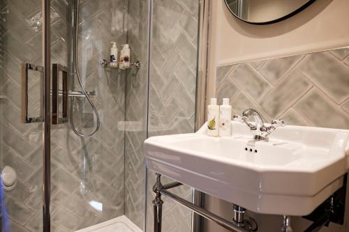 a bathroom with a sink and a shower at Bear Of Burton in Christchurch
