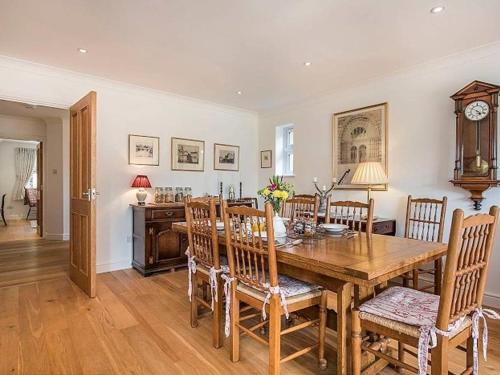 a dining room with a wooden table and chairs at Knole B&B in Sevenoaks