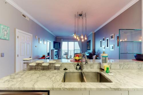a kitchen with a sink and a counter top at Ocean Villa in Panama City Beach
