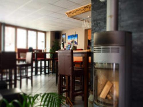 a restaurant with a bar with chairs and tables at Weincafé Korkenzieher in Briedel