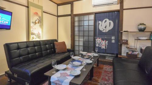 a living room with a couch and a table at Kyougetsu-an in Kyoto