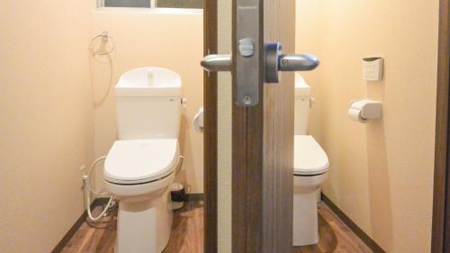 a bathroom with two toilets in a bathroom stall at Kyougetsu-an in Kyoto