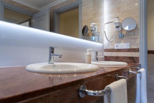 a bathroom with two sinks and a large mirror at Playa de las Americas Apartments in Playa de las Americas