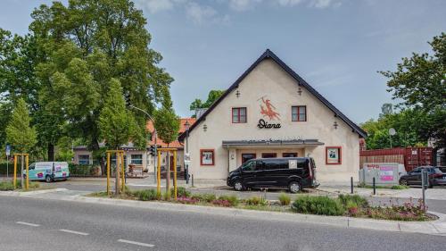 a black van parked in front of a building at Landhotel Diana in Teltow