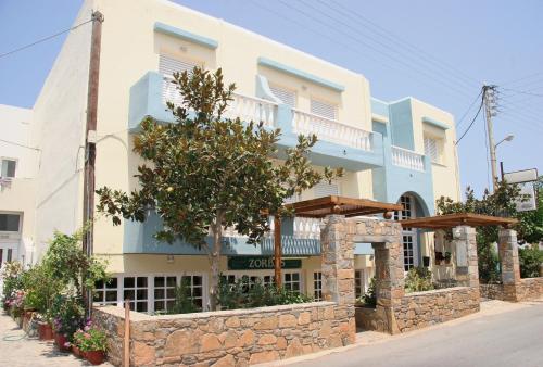 a building with a stone wall in front of it at Sissi Mare Apartments in Sissi