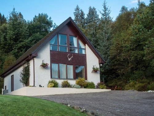 a house with a large window on the side of it at Lann Dearg Studios in Invermoriston