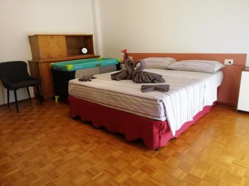 a bedroom with a bed with a teddy bear on it at Rosso Tirano in Tirano