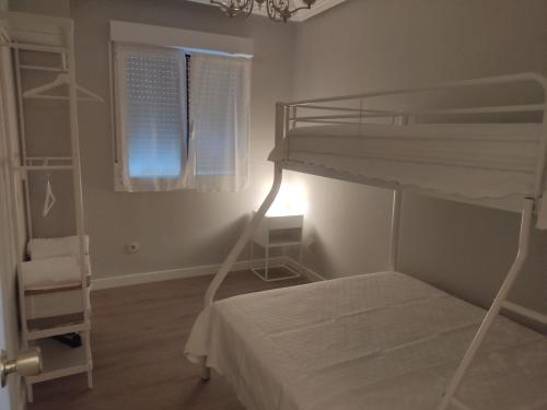 a bedroom with a bunk bed and a window at Las Ildas in Anguiano