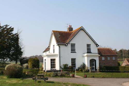 a white house with a brown roof at Lower Bryanston Farm in Blandford Forum