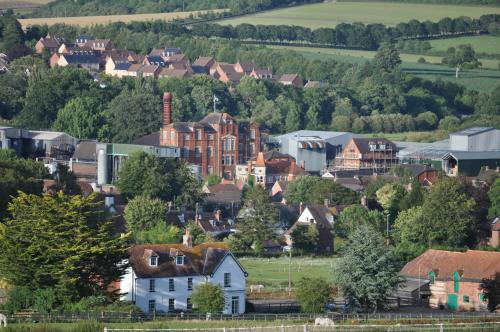 a town with houses and trees in the distance at Lower Bryanston Farm in Blandford Forum