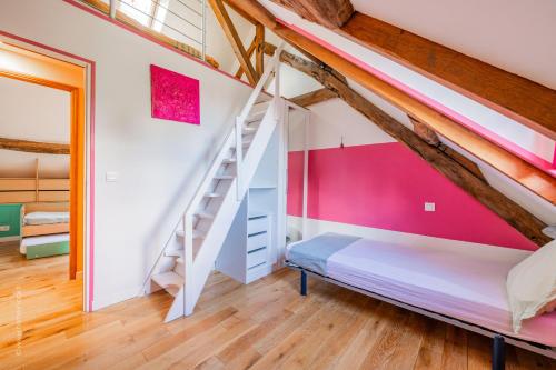 a bedroom with a bunk bed and a staircase at Le Colombier - Fairytale Factory in Montgeroult