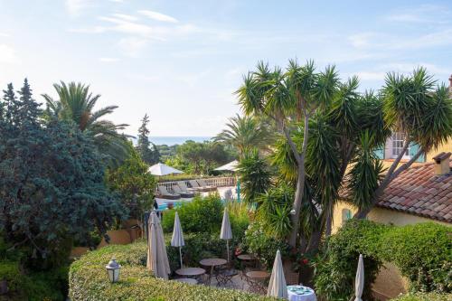 a view of a resort with tables and umbrellas at Le Pavillon de Pampelonne in Saint-Tropez