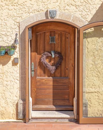 a wooden door with a heart shaped wreath on it at Le Pavillon de Pampelonne in Saint-Tropez