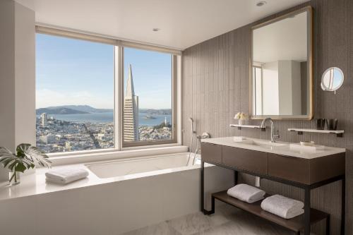 a bathroom with a tub and a sink and a large window at Four Seasons Hotel San Francisco at Embarcadero in San Francisco
