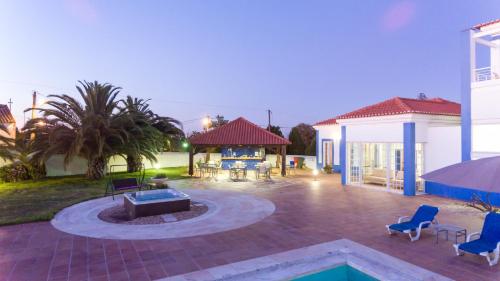 a patio with chairs and a fire pit in a house at HOTEL LOUSAL Grandola in Lousal