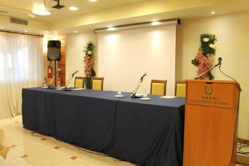 a meeting room with a long table with microphones at Grand Hotel Victoria in Bagnara Calabra