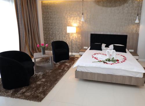 a bedroom with a bed with a flower wreath on it at MELISS EVENTS in Craiova