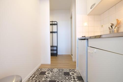 Il comprend une cuisine avec un comptoir et du carrelage. dans l'établissement Les Studiantes - T1 32 m² hypercentre gares/métro, à Lille