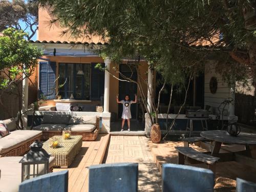 une femme debout sur le patio d'une maison dans l'établissement L'Instant - La Capte, à Hyères