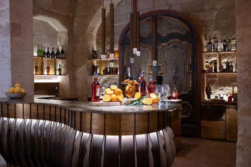 a bar with a counter in a room with bottles at Pollicastro Boutique Hotel in Lecce