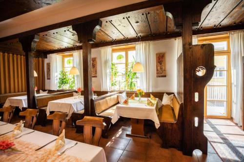 a restaurant with tables and chairs in a room at Landgasthof Sonne in Lauchheim