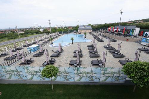 an empty swimming pool with chairs and a pool at MELISS EVENTS in Craiova