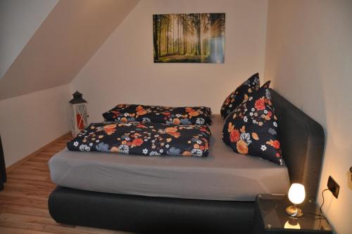 a couch with two pillows on it in a room at Rentrisch am Waldrand in Sankt Ingbert