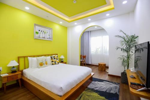 a bedroom with a large bed and a tv at Chez Mimosa Local in Ho Chi Minh City