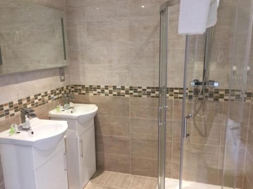 a bathroom with a sink and a shower at The Marlborough Hotel in Liverpool