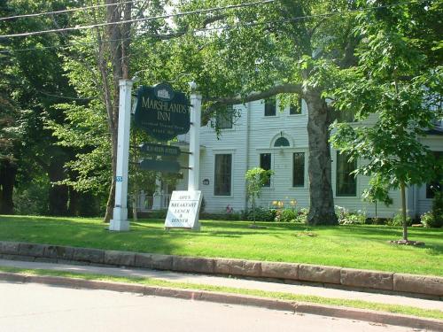 a street sign in front of a white house at Marshlands Inn in Sackville