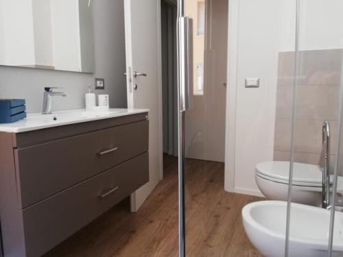 a bathroom with a sink and a toilet and a shower at HouseSandra Mare & Sole in Alghero