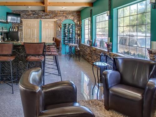a bar with leather chairs and a barber shop at Leavenworth Village Inn in Leavenworth