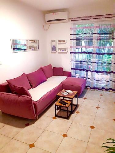 - un salon avec un canapé violet et une table dans l'établissement Dream apartment Herceg Novi, à Herceg-Novi