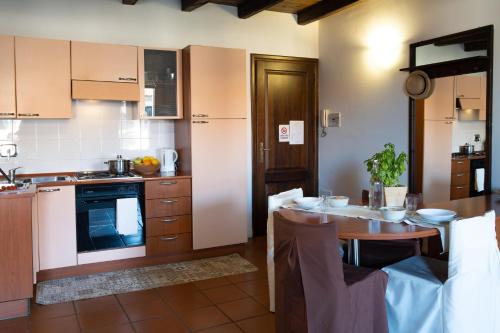 a kitchen with a table and a dining room at Residence Ferraud in Pinerolo