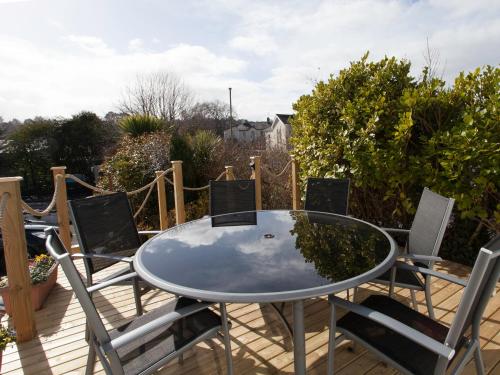une table et des chaises en verre sur une terrasse dans l'établissement Mount Edgcombe, à Torquay