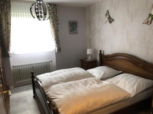 a bedroom with a bed and a window with butterflies on the wall at Alicia in Winterberg