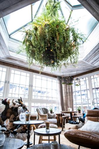 a large living room with a large chandelier at Lifestyle Hotel eder in Maria Alm am Steinernen Meer