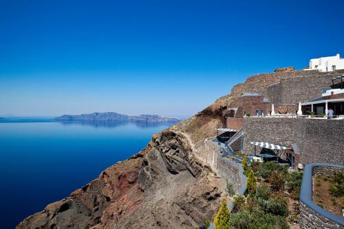 a view of the side of a mountain with water at San Antonio - Small Luxury Hotels of the World in Imerovigli