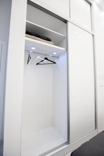a room with white cabinets and a window at Theatre Square Apartments in Novi Sad