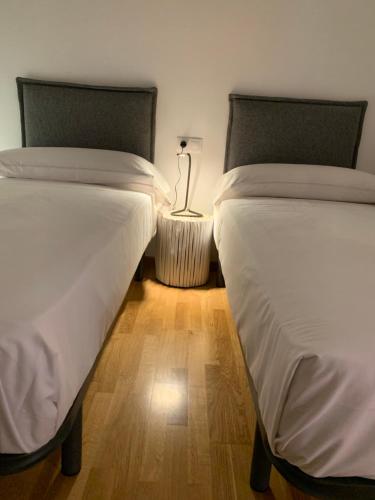 two beds sitting next to each other in a room at Oktheway Pedro Saco Street in Sarria