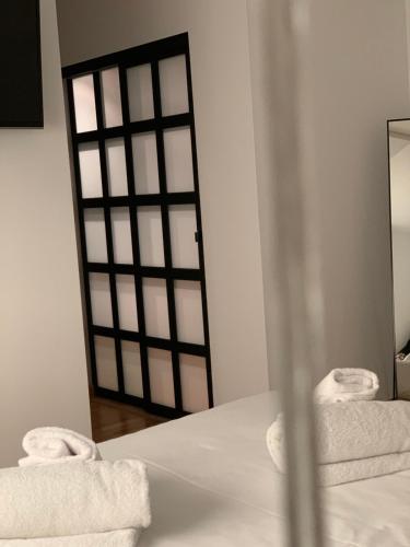 a room with towels on a bed and a mirror at Oktheway Pedro Saco Street in Sarria