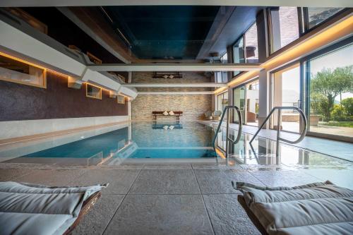 a swimming pool in the middle of a house at Hotel Patriarch in Tirolo