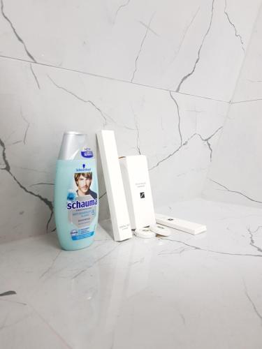 a bottle of sakura calcium cleaner sitting on a bathroom counter at Prishtina Newborn ABC room in Pristina