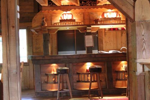 un bar en una habitación con dos taburetes en Chalet de Charme Le Cécla en Passy